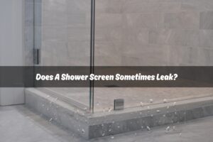 Close-up of a glass shower screen in a modern bathroom, showing water droplets on the floor, suggesting a possible leak. The image emphasizes the issue of "Shower Screen Leak," highlighting concerns about water escaping from the shower area.