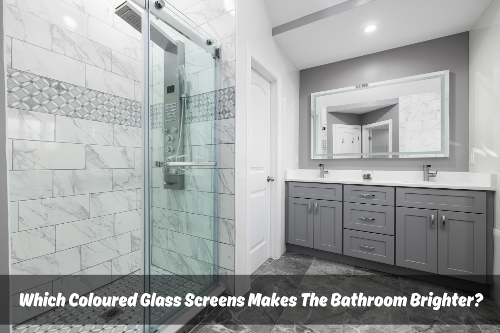 A modern bathroom featuring a glass shower enclosure with grey accents and white marble tiles. The shower screen is clear glass, and the bathroom is well-lit with a large mirror and grey vanity. This image highlights the use of coloured glass screens to enhance bathroom brightness.